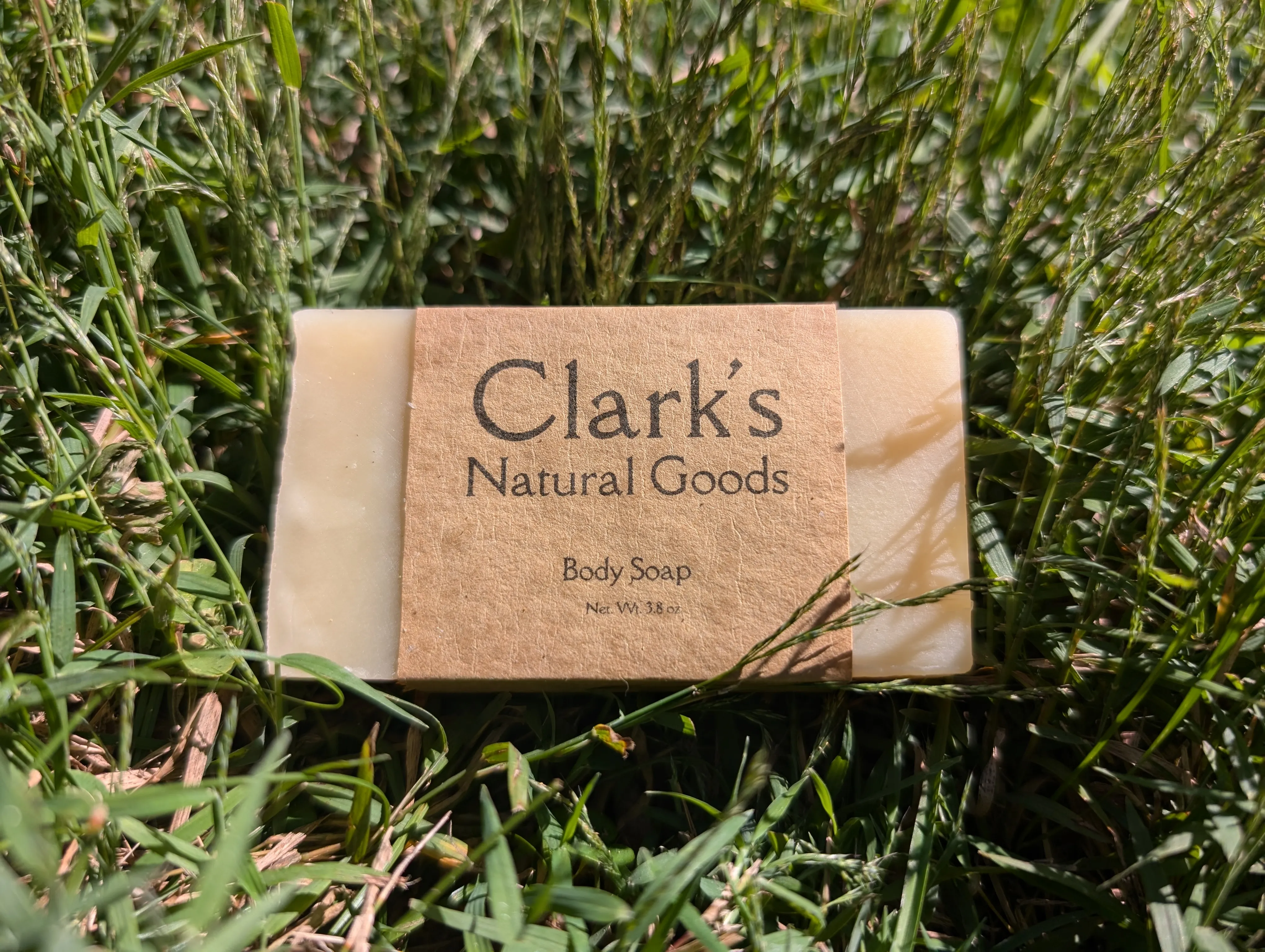 Handmade soap resting on a field of grass